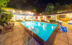 a swimming pool in a house at night at Pousada Pedra D'Água Pipa in Pipa +15 photos
