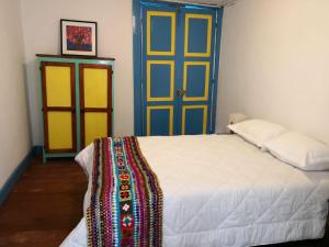 a bedroom with a bed and a colorful door at Hotel Salento 1842 in Salento