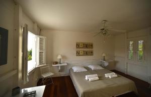 a bedroom with a bed with two towels on it at La Villa du soleil in Les Trois-Îlets