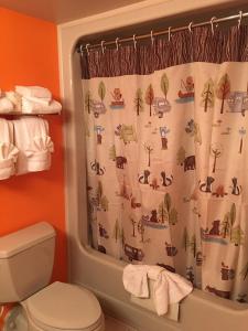 a bathroom with a toilet and a shower curtain at Laughlin River Lodge in Laughlin