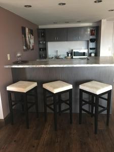 a kitchen with two bar stools and a counter at Laughlin River Lodge in Laughlin