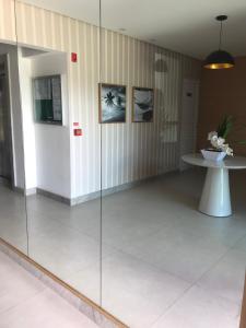 a glass partition in a room with a table at Vog Torres do Sul in Ilhéus +34 photos