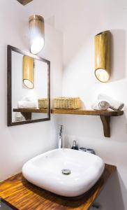 a bathroom with a white sink and a mirror at Fisheye The Rooms - Family room in El Nido