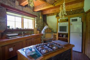 a kitchen with a stove top and a refrigerator at Galexy Lounge in Burkes Pass