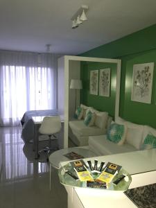 a living room with a couch and a table at 9 de Julio Park Suites in San Miguel de Tucumán