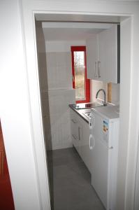 a white kitchen with a sink and a dishwasher at Kegel Tanz Palast Winterberg in Winterberg