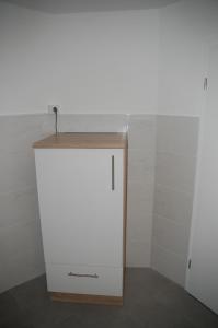 einen weißen Schrank mit einer Holzplatte in einem Zimmer in der Unterkunft Kegel Tanz Palast Winterberg in Winterberg