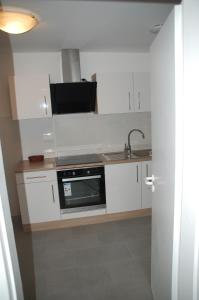 a kitchen with a sink and a microwave at Kegel Tanz Palast Winterberg in Winterberg