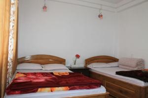 Postel nebo postele na pokoji v ubytování Vamoose Olive Homestay Aritar