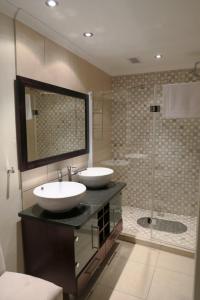 a bathroom with two sinks and a shower at Sea-View Nautica @ Mossel Bay in Mossel Bay