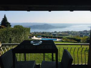 a table and chairs on a balcony with a view at Villa Marisa in Nebbiuno +23 photos