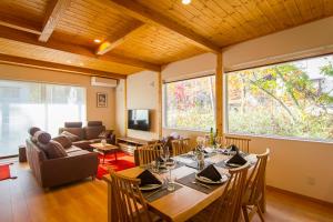 a living room filled with furniture and a tv at Morino Chalets in Hakuba