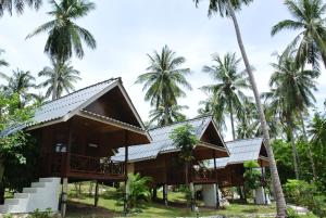 a resort with palm trees in the background at Seashell Coconut Village Koh Tao in Ko Tao
