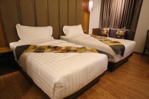 Postel nebo postele na pokoji v ubytování Lavana Hotel Chiangmai