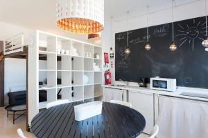 a kitchen with a table and a chalkboard on the wall at In Bed with Lisbon 5N in Amadora