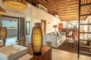 a living room with a white tub and a couch at Casa HM Villa del Mar in Holbox Island