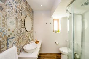 a bathroom with a sink and a toilet and a shower at Viewpoint Boutique Living in Xlendi