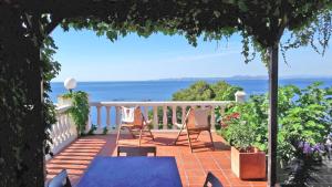 a balcony with two chairs and a view of the ocean at Breathtaking Costabrava seaview apartment 5m beach - Casa ArteVida in Roses