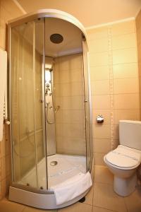 a bathroom with a shower and a toilet at Voila Inn in Constanţa