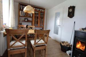 a dining room with a table and chairs and a fireplace at Marienhof in Leibertingen