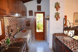 a kitchen with a sink and a counter top at Ammiraglio - Villa Ziri in Giglio Porto