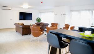 a living room with a table and chairs and a couch at Hotel Ikast in Ikast