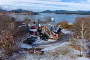 an aerial view of a house with snow and water at Back from the Ashes in Southwest Harbor