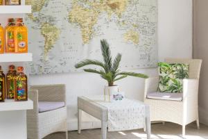 a table and chairs with a world map on the wall at Hevea Hotel in Grand Case