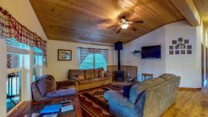 a living room with couches and a wooden ceiling at Sequoia in South Fork