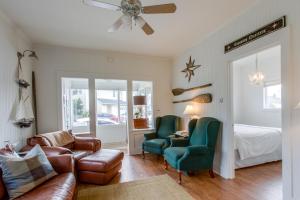 a living room with a couch and chairs and a bed at Seaside Cottage in Seaside