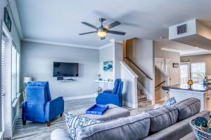 a living room with a couch and two blue chairs at Pathway 14820 in Padre Island