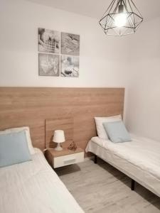 a bedroom with two beds and a lamp on a table at Apartamenty Homole C2 Szczawnica in Szczawnica +19 photos