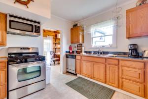 a kitchen with wooden cabinets and stainless steel appliances at The River Belle in Seaside