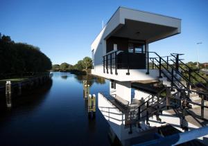 a house on a boat on a river at SWEETS - Meeuwenpleinbrug in Amsterdam