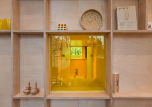 a model of a house with a yellow window at SWEETS - Nieuwe Amstelbrug in Amsterdam +10 photos