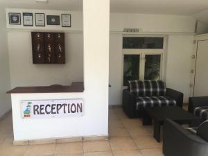 a waiting room with a reception sign on the wall at Raja Beach Hotel in Balapitiya