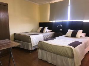 Un pat sau paturi într-o cameră la Inti Hotel