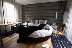 a bedroom with a large black and white bed at Magnifique Luxury Suites in Thessaloniki