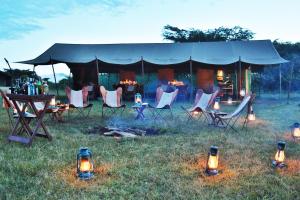 a group of chairs and tables under a tent at Pakulala Safari Camp - Ngorongoro in Ngorongoro