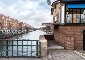 a view of a river with buildings and a building at SWEETS - Overtoomsesluis in Amsterdam