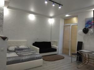 a bedroom with a bed and a couch in it at Шикарные Апартаменты in Polatsk