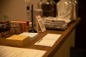 a counter with a printer and other items on it at bnb+ Secret Base Mejiro in Tokyo