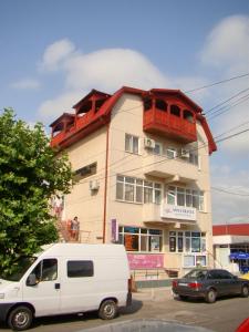 a white van parked in front of a building at OITUZ Boutique Residence in Mangalia
