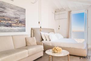 a living room with a bed and a couch at Il Sogno di Manarola by The First in Manarola