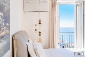 a bedroom with a bed and a view of the ocean at Il Sogno di Manarola by The First in Manarola