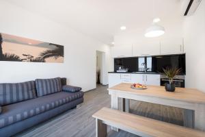 a living room with a couch and a table at Marojica Apartments 2 in Cavtat