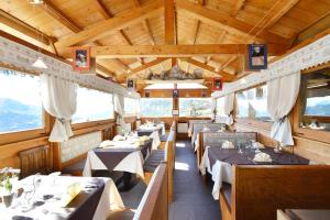 a dining car of a train with tables in it at Affittacamere De Charme Jour Et Nuit in Torgnon