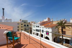 a chair on the balcony of a building at Holiday Home Casa Nova by Mauter Villas in Ciutadella