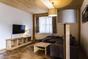 a living room with a couch and a tv at Zeidelhof in Lilienfeld