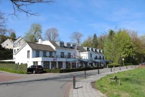 a large white building on the side of a road at Saillant Hotel Gulpenerland - Auping Hotel Partner in Gulpen